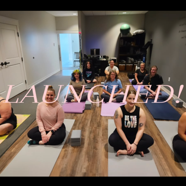 yoga room with mats and people sitting in yoga posted with the text launched