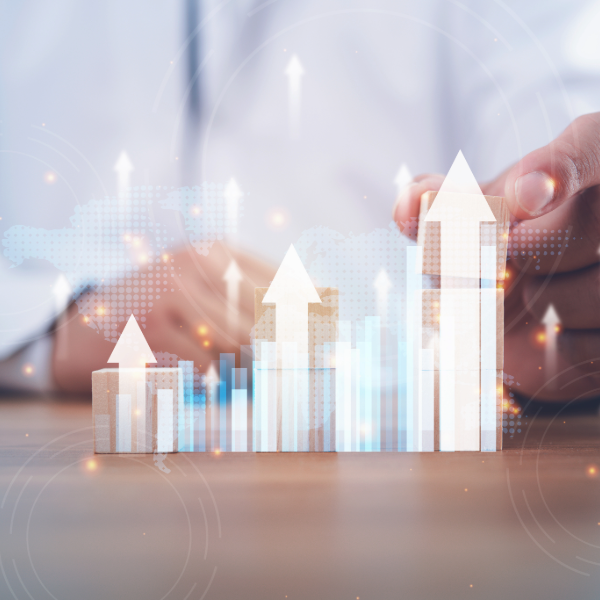 a man's hands showing illustrated arrows going up to depict growing revenue