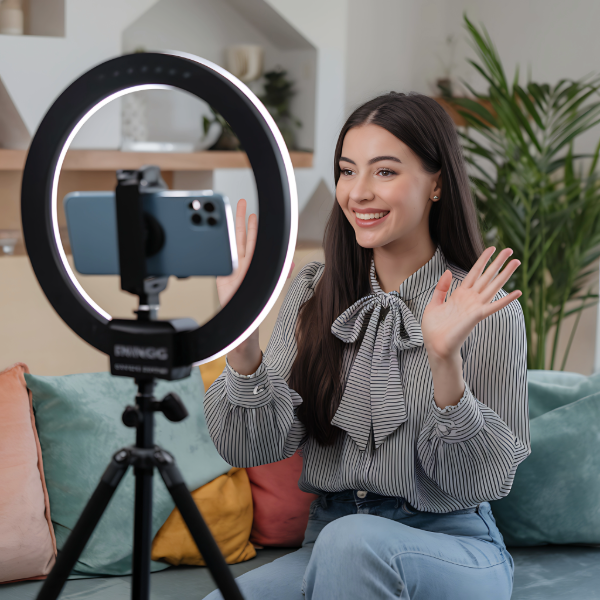 podcaster with ring light filming and waving